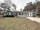 Charming single-story home with a welcoming front porch and a neat lawn at 464 Stonewood Dr, Stone Mountain, GA 30087