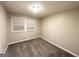Empty bedroom with carpet flooring, neutral-colored walls, and window blinds at 3429 Adkins Nw Rd, Atlanta, GA 30331