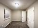 Empty bedroom with carpet flooring, neutral-colored walls, and open door to another room at 3429 Adkins Nw Rd, Atlanta, GA 30331