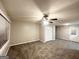 Empty living room with neutral-colored walls, carpet flooring, and ceiling fan at 3429 Adkins Nw Rd, Atlanta, GA 30331