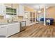 Kitchen with granite countertops, white cabinets and view of Gathering room at 232 Terrane Rdg, Peachtree City, GA 30269