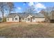 Exterior view of a two-story house with a backyard and trees at 65 Five Oaks Dr, Covington, GA 30014