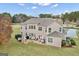 Spacious backyard featuring a patio area with outdoor furniture, fireplace, and lush greenery at 115 Haddonstone Dr, Fayetteville, GA 30215