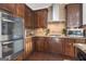 Modern kitchen featuring stainless steel double ovens, a gas cooktop, and ample cabinetry at 115 Haddonstone Dr, Fayetteville, GA 30215