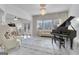 Living room with grand piano, tufted sofa, and stylish armchairs at 115 Haddonstone Dr, Fayetteville, GA 30215