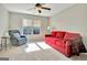 Spacious bedroom with red couch and ceiling fan at 121 Lexington Pass, Peachtree City, GA 30269