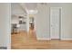 Bright and spacious hallway with hardwood floors leading to the kitchen at 121 Lexington Pass, Peachtree City, GA 30269