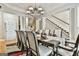 Dining room with tray ceiling, chandelier, and seating for eight at 165 Standing Oak Pl, Fayetteville, GA 30214