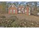 Classic brick home with white trim and landscaping at 165 Standing Oak Pl, Fayetteville, GA 30214