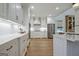 White kitchen with modern appliances, white cabinets, and light countertops at 714 Magnolia Walk, Peachtree City, GA 30269