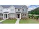 Well-maintained townhome exterior with brick accents, green lawn, and inviting entryways at 1019 Cades Walk, Lawrenceville, GA 30045