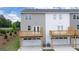 Townhome rear view with private deck and garages, modern design and new construction at 1019 Cades Walk, Lawrenceville, GA 30045
