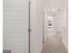 Hallway featuring neutral carpet, bright white walls, and view of the bedroom window at 1019 Cades Walk, Lawrenceville, GA 30045