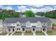 Aerial view of new townhomes with sidewalks and manicured landscaping at 1019 Cades Walk, Lawrenceville, GA 30045