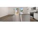 Bright, open kitchen featuring stainless steel appliances, granite countertops, and a large island with doors to the outside deck at 1019 Cades Walk, Lawrenceville, GA 30045