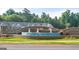 Stone entrance to Inverness at Sugarloaf community with water feature and landscaping at 1019 Cades Walk, Lawrenceville, GA 30045
