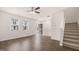 Bright, open living space with wood-look floors, fan, and staircase leading to upper level at 1019 Cades Walk, Lawrenceville, GA 30045