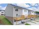 Rear view of townhomes showcasing wooden decks, walkout garages, and modern gray siding at 1019 Cades Walk, Lawrenceville, GA 30045