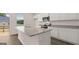 Modern kitchen boasting white cabinets, granite countertops, and stainless steel appliances with an island and door to the outside deck at 1019 Cades Walk, Lawrenceville, GA 30045
