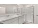 Bright bathroom features double sinks with a glass enclosed shower and marble countertops at 1019 Cades Walk, Lawrenceville, GA 30045