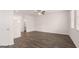 Open-concept living area with wood-look floors, fan, and abundant natural light at 1019 Cades Walk, Lawrenceville, GA 30045