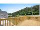 A wood deck with views of a quiet green space, trees and a nearby road at 1019 Cades Walk, Lawrenceville, GA 30045
