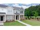 Charming townhome with brick and gray siding, a well-maintained lawn, and inviting front entrance at 1019 Cades Walk, Lawrenceville, GA 30045