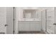 Ensuite bathroom featuring double sinks, marble countertop and a glass shower at 1019 Cades Walk, Lawrenceville, GA 30045