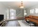 Open-concept living room featuring hardwood floors, a cozy sofa, and a staircase at 435 Tellico Sw, Atlanta, GA 30331