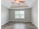 Bright bedroom featuring wood floors, a ceiling fan and a large window at 435 Tellico Sw, Atlanta, GA 30331