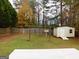 Fenced backyard with storage shed, clothesline, and wooden deck at 6618 Dottie Mae Ct, Morrow, GA 30260