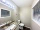 Bathroom with granite vanity top, white cabinetry, and a toilet at 1519 Pine Glen Cir, Decatur, GA 30035