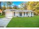 Charming renovated ranch home with a lush green lawn, driveway, and covered entryway at 1519 Pine Glen Cir, Decatur, GA 30035
