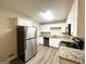 Modern kitchen featuring white shaker cabinets, stainless steel appliances, and granite countertops at 1519 Pine Glen Cir, Decatur, GA 30035