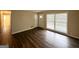 Bright, open living area with wood-look flooring, white walls, and windows with blinds at 1519 Pine Glen Cir, Decatur, GA 30035