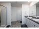 Modern bathroom with double vanity, shower, and tiled floor at 1304 Speckle Park Way, Stockbridge, GA 30281