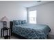 Cozy bedroom with a comfortable bed and window with blinds at 1304 Speckle Park Way, Stockbridge, GA 30281