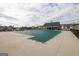 Community pool with a cover, surrounded by a concrete deck at 1304 Speckle Park Way, Stockbridge, GA 30281