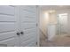 Hallway with white doors and neutral carpet at 1304 Speckle Park Way, Stockbridge, GA 30281