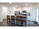 Modern kitchen with white cabinets, stainless steel appliances, and an island with seating at 1304 Speckle Park Way, Stockbridge, GA 30281