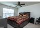 Spacious main bedroom with a king-size bed, ceiling fan, and large window at 1304 Speckle Park Way, Stockbridge, GA 30281