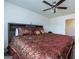Large main bedroom with a king-size bed and ceiling fan at 1304 Speckle Park Way, Stockbridge, GA 30281