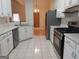 Kitchen with white cabinets, stainless steel appliances, and tile floor at 2322 Runnymede Ct, Jonesboro, GA 30236