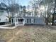 Single-story home with a covered front porch, surrounded by trees at 2556 Godfrey Nw Dr, Atlanta, GA 30318