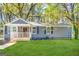 Charming blue single-story home with a covered front porch and landscaped yard at 2556 Godfrey Nw Dr, Atlanta, GA 30318