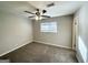 Empty bedroom with neutral gray walls, carpeting, ceiling fan, and window at 261 Howell Sw Ter, Atlanta, GA 30331
