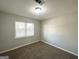 Bright bedroom with large windows and neutral-colored carpet at 261 Howell Sw Ter, Atlanta, GA 30331