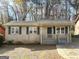 Single-Gathering home with a covered porch and driveway at 261 Howell Sw Ter, Atlanta, GA 30331