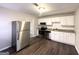 Updated kitchen with stainless steel appliances, white cabinets, and granite countertops at 261 Howell Sw Ter, Atlanta, GA 30331
