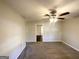 Spacious living room with neutral walls, plush carpet, and a ceiling fan at 261 Howell Sw Ter, Atlanta, GA 30331